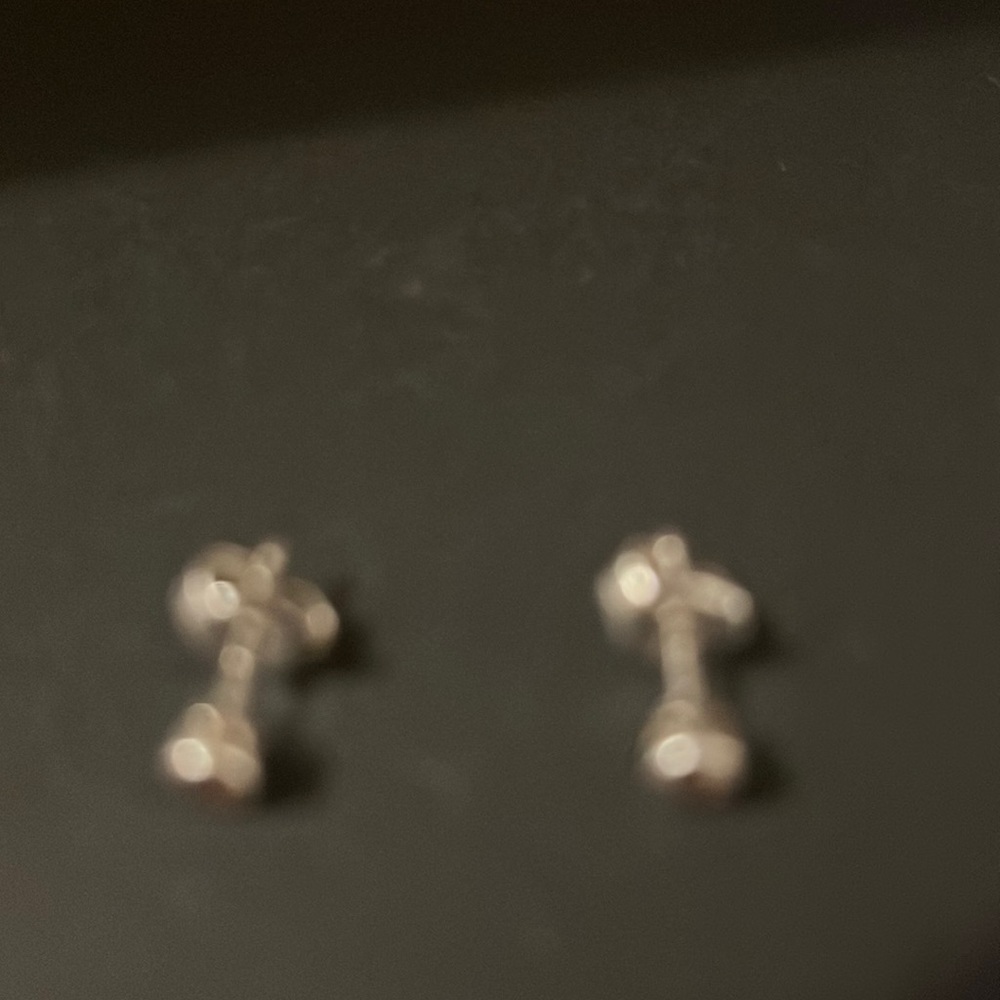 Diamond earrings, 0.05 in size.
